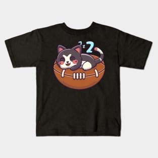 Cat napping on a American football Kids T-Shirt